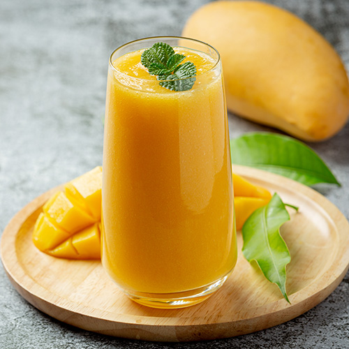 Mango juice in the glass on dark backgroud